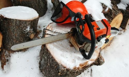 using a chainsaw in the snow